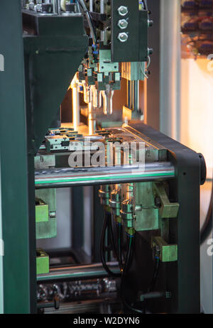 Process of PET plastic bottle on plastic Bottle blowing machine Stock Photo