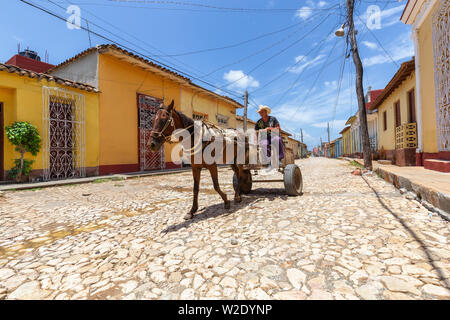 Trinidad, Cuba - June 9, 2019: Horse Carriage in the streets of a small Cuban Town during a vibrant sunny day. Stock Photo