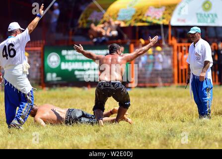 Ankara, Turkey. 7th July, 2019. Wrestlers are seen during the traditional Kirkpinar Oil Wrestling Festival in Edirne, Turkey, July 7, 2019. Turkey's Kirkpinar Oil Wrestling Festival is a centuries-old traditional sport event, in which sportsmen covered with olive oil compete to win a prestigious golden belt. TO GO WITH Feature: Turkey braces for major traditional oil wrestling tournament. Credit: Ihlas News Agency/Xinhua/Alamy Live News Stock Photo