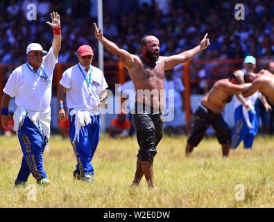 Ankara, Turkey. 7th July, 2019. A wrestler gestures during the traditional Kirkpinar Oil Wrestling Festival in Edirne, Turkey, July 7, 2019. Turkey's Kirkpinar Oil Wrestling Festival is a centuries-old traditional sport event, in which sportsmen covered with olive oil compete to win a prestigious golden belt. TO GO WITH Feature: Turkey braces for major traditional oil wrestling tournament. Credit: Ihlas News Agency/Xinhua/Alamy Live News Stock Photo