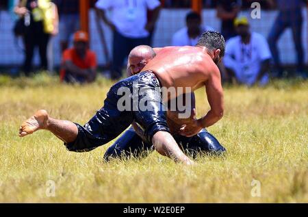 Ankara, Turkey. 7th July, 2019. Wrestlers compete during the traditional Kirkpinar Oil Wrestling Festival in Edirne, Turkey, July 7, 2019. Turkey's Kirkpinar Oil Wrestling Festival is a centuries-old traditional sport event, in which sportsmen covered with olive oil compete to win a prestigious golden belt. TO GO WITH Feature: Turkey braces for major traditional oil wrestling tournament. Credit: Ihlas News Agency/Xinhua/Alamy Live News Stock Photo