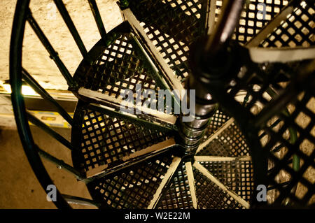 A downward view of an iron spiral staircase Stock Photo