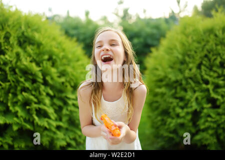 Adorable Little Girl Playing with Water Gun on Hot Summer Day. Cute Child  Having Fun with Water Outdoors Stock Photo - Image of leisure, beautiful:  97180460