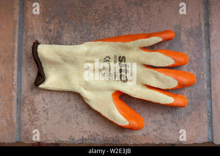 Closeup photograph of a left handed garden safety glove with rubber protection Stock Photo