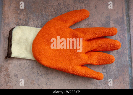Closeup photograph of a left handed garden safety glove with rubber protection Stock Photo
