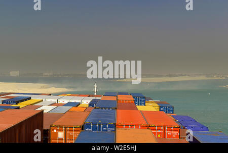 suez canal, egypt - january 06, 2105 -- the containership cma cgm vela ( imo 9354923)  transiting the suez canal near km 80e during a sandstorm, backg Stock Photo