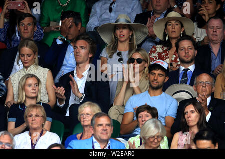 Poppy Delevingne and James Cook (left) with Derek Blasberg and Sienna Miller (right) on day seven of the Wimbledon Championships at the All England Lawn Tennis and Croquet Club, Wimbledon. Stock Photo