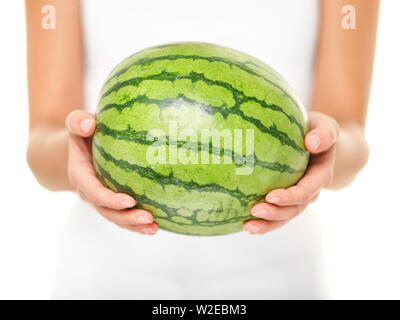 Watermelon. Woman showing whole watermelon on isolated white background. Closeup of water melon. Stock Photo