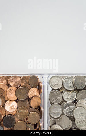 Isolated organized loose coin change on bottom side, white background, blank empty room space for copy or text on top. Financial organization money co