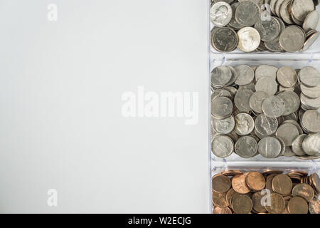 Isolated organized loose coin change on right side, white background, blank empty room space for copy or text on left. Financial organization money co Stock Photo