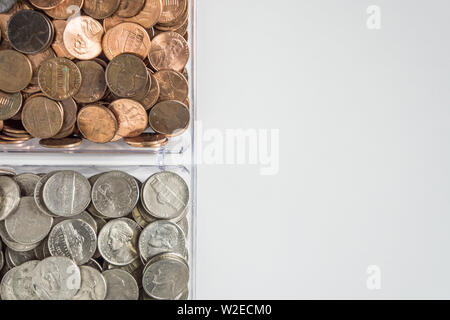 Isolated organized loose coin change on left side, white background, blank empty room space for copy or text on right. Financial organization money co Stock Photo