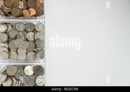 Isolated organized loose coin change on left side, white background, blank empty room space for copy or text on right. Financial organization money co Stock Photo