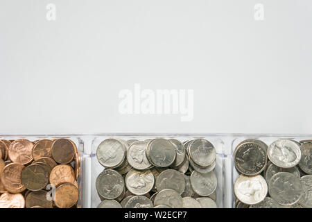 Isolated organized loose coin change on bottom side, white background, blank empty room space for copy or text on top. Financial organization money co Stock Photo
