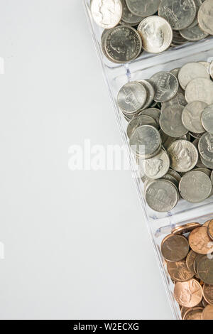 Isolated organized loose coin change on right side, white background, blank empty room space for copy or text on left. Financial organization money co Stock Photo