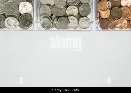 Isolated organized loose coin change on top side, white background, blank empty room space for copy or text on bottom. Financial organization money co Stock Photo