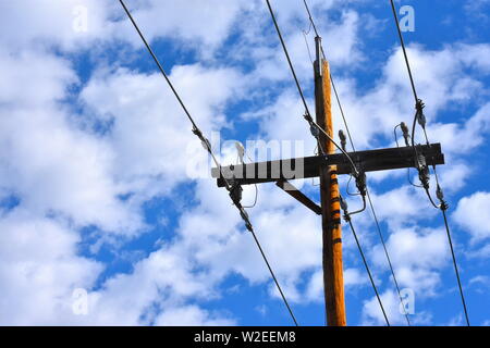 Low angle view of a telephone pole with a sky background Stock Photo