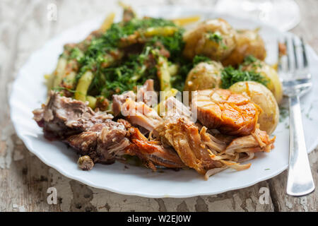 Roast pork with green beans & baby potatoes Stock Photo