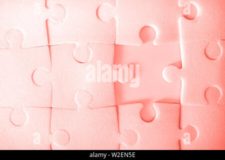 Multiple yellow puzzle pieces put together without one piece. View from above. Close up trendy monochrome image. Stock Photo
