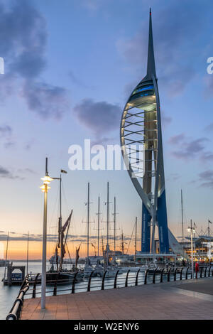Portsmouth, Hampshire, England. After a hot and humid day on the Hampshire coast, the lights come on at Gunwharf Quays as the sun sets over Portsmouth Stock Photo