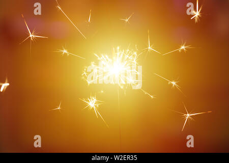 Sparks from hand cold fireworks color background Stock Photo