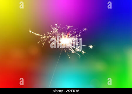 Sparks from hand cold fireworks colorful background Stock Photo