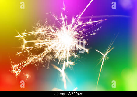 Sparks from hand cold fireworks colorful background Stock Photo