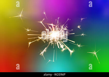 Sparks from hand cold fireworks color background Stock Photo