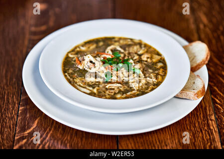 Polish beef tripe soup served on wooden table Stock Photo