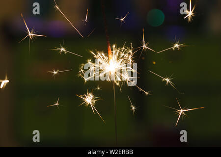 Sparks from hand cold fireworks color background Stock Photo