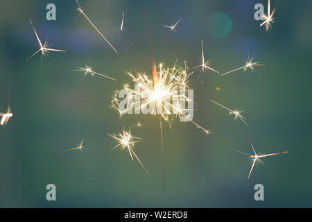 Sparks from hand cold fireworks color background Stock Photo
