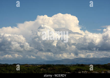 These clouds towering over the moumtains of North Wales. They often result in thunder storms and heavy rain Stock Photo