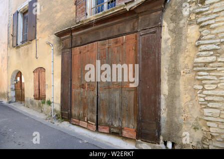 Traditional Old Wooden Shop Front & Closed or Vacant Village Shop, Corner Shop or Store Goult Luberon Provence France Stock Photo