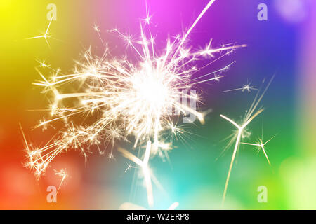Sparks from hand cold fireworks colorful background Stock Photo
