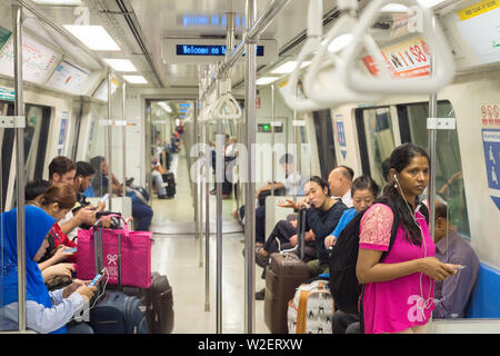 SINGAPORE - JAN 13, 2017: Passengers in Singapore Mass Rapid Transit (MRT) train. The MRT has 102 stations and is the second-oldest metro system in So Stock Photo