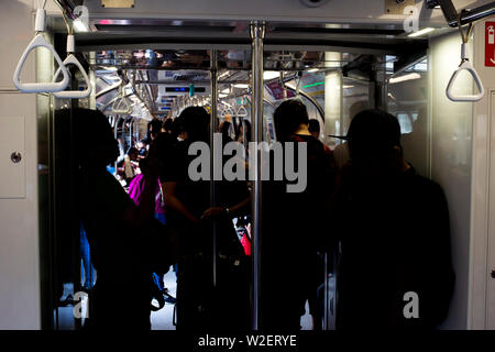 Passengers in Singapore Mass Rapid Transit (MRT) train. The MRT has 102 stations and is the second-oldest metro system in Southeast Asia Stock Photo