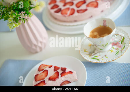 Fresh cheesecake with strawberries on a table Stock Photo