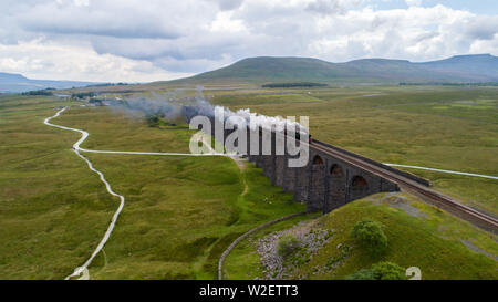 7th July 2019, Ribblehead Viaduct, Ribblehead;  Flying Scotsman crossing Ribblehead Viaduct ; The iconic Flying Scotsman, first steam to train to hit 100mph in the UK crosses the beautiful and remote Ribblehead viaduct in the Yorkshire Dales National Park  Credit: Thom Jones/News Images Stock Photo