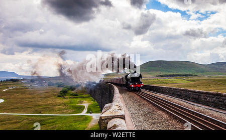 7th July 2019, Ribblehead Viaduct, Ribblehead;  Flying Scotsman crossing Ribblehead Viaduct ; The iconic Flying Scotsman, first steam to train to hit 100mph in the UK crosses the beautiful and remote Ribblehead viaduct in the Yorkshire Dales National Park  Credit: Thom Jones/News Images Stock Photo