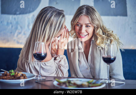 Two girl friends eating lunch in restaurant Stock Photo