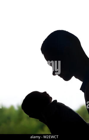 Silhouette of new father admiring his precious newborn child Stock Photo