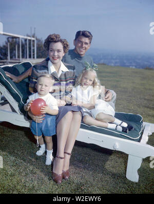 RONALD REAGAN (1911-2004) American film actor and later President with his first wife Jane Wyman and their children Maureen and Michael about 1946 Stock Photo