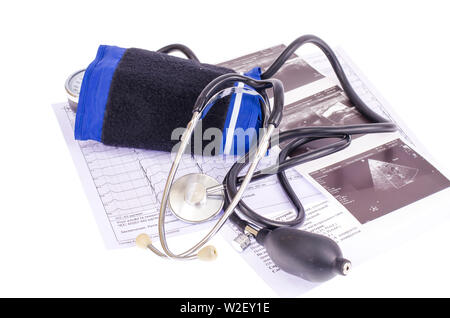 Analog blood pressure meter (tonometer) and notepad on the background of medical graphs, diagnostics. Healt concept. Stock Photo