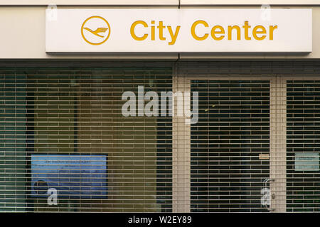 Frankfurt, Germany - July 06, 2019: The logo of the travel agency Lufthansa City Center over the barred shop window of a closed shop on 06 July 2019 i Stock Photo