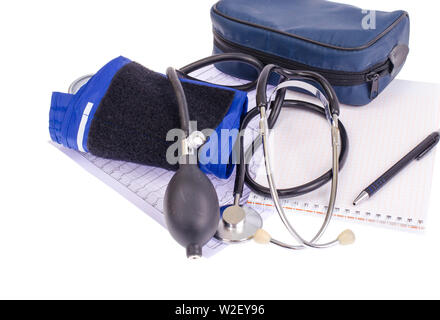 Analog blood pressure meter (tonometer) and notepad on the background of medical graphs, diagnostics. Healt concept. Stock Photo