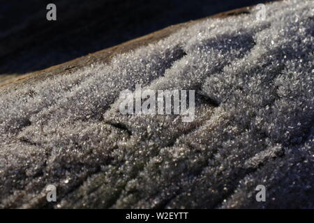 Frost on a Driftwood Tree Trunk. Aberdeen Beach, Scotland, UK. Stock Photo