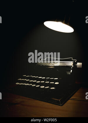 Typewriter with a spotlight on top of it. Stock Photo