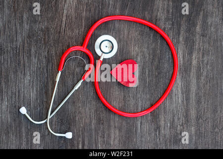 Stethoscope and red heart on wooden background. Health care concept Stock Photo