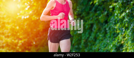 Young sporty man running on sunny day Stock Photo