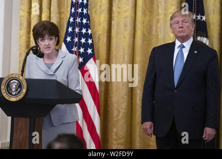 Washington, District of Columbia, USA. 8th July, 2019. Chair of the Council on Environmental Quality Mary Neumayr, left, makes remarks on 'America's Environmental Leadership'' as United States President Donald J. Trump, right, listens in the East Room of the White House in Washington, DC on Monday, July 8, 2019. Credit: Ron Sachs/CNP/ZUMA Wire/Alamy Live News Stock Photo