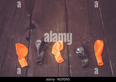 Halloween Balloons on dark wood. Halloween party decorations. Happy Halloween concept. Stock Photo